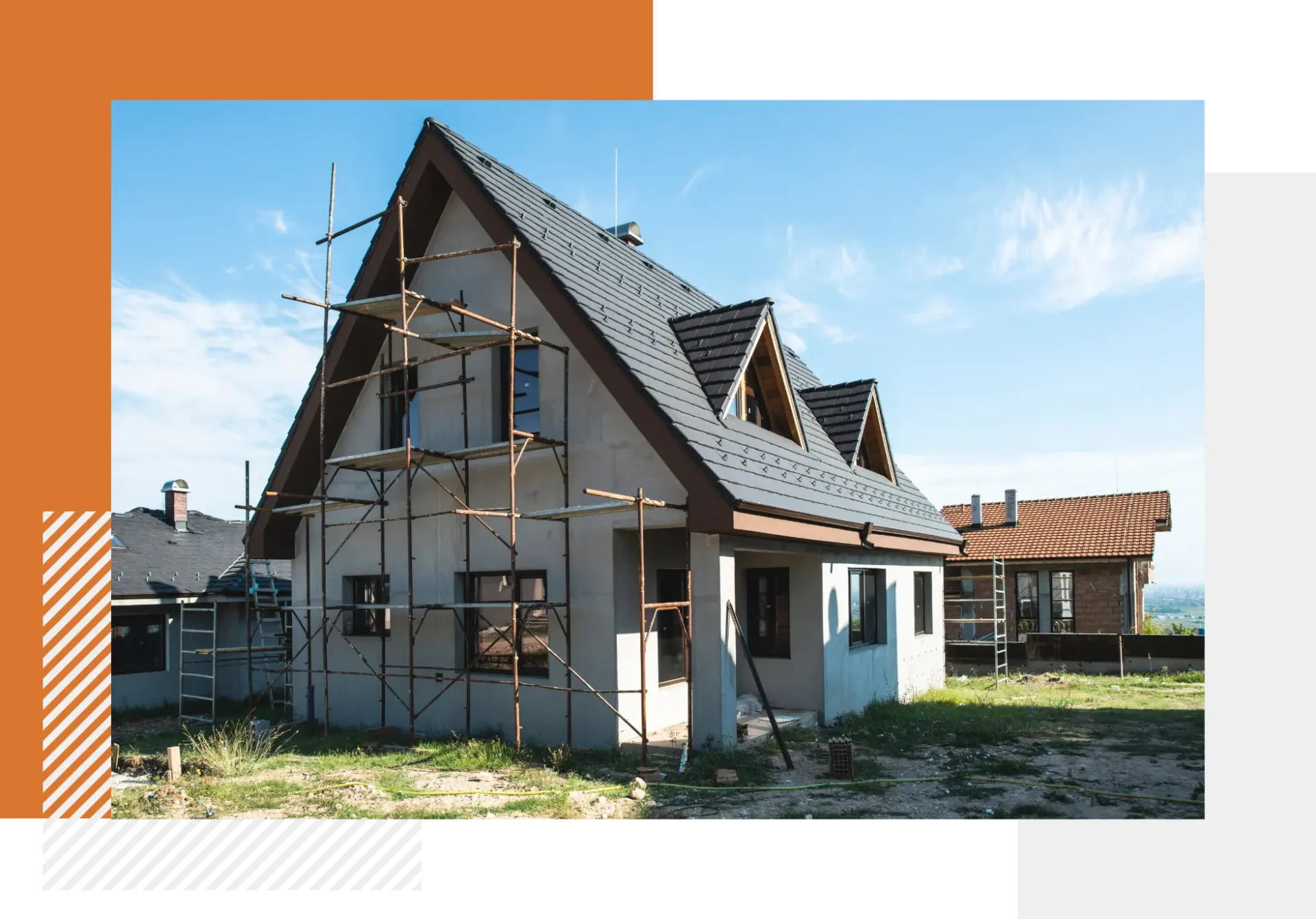 A house with scaffolding around it and some houses in the background.