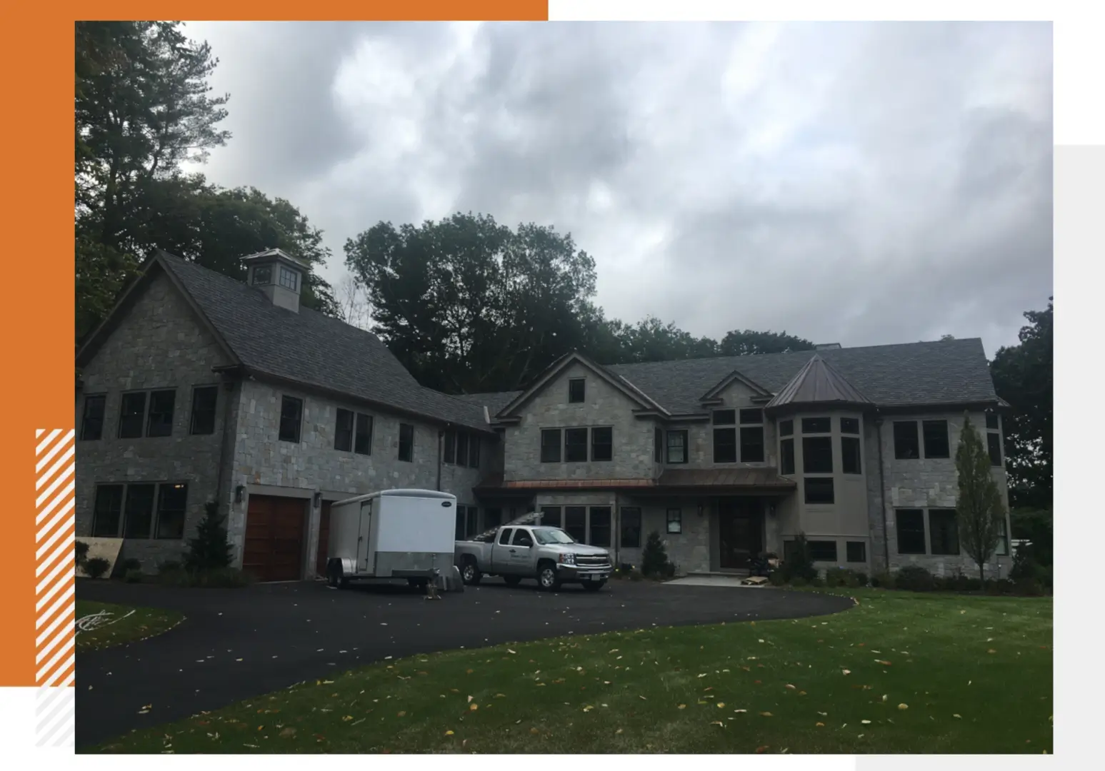 A large house with cars parked in front of it.